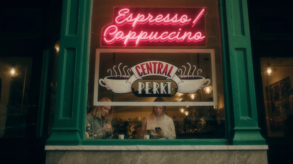 Two people at a café window with coffee